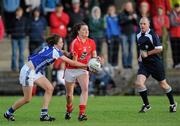 27 August 2011; Annie Walsh, Cork, in action against jane Moore, Laois, under the watchful eye of referee Gavin Corrigan. TG4 All-Ireland Ladies Senior Football Championship Semi-Final, Cork v Laois, Leahy Park, Cashel, Co. Tipperary. Picture credit: Brian Lawless / SPORTSFILE