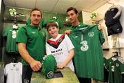 30 August 2011; Republic of Ireland players Liam Lawrence, left, and Stephen Kelly pictured with Cian Maxwell, age 11, from Maynooth, Co. Kildare, at a surprise Three Trade In visit to Champion, Jervis Street. Three is asking Irish fans to Go Green With Pride and trade in their old Republic of Ireland football jerseys in any Champion store nationwide and get €20 off the new home jersey. The traded in jerseys will be donated to Friends In Ireland, a charity founded by Marian Finucane. The scheme will run until September 30th. Champion Sports, Jervis Centre, Dublin. Picture credit: Brian Lawless / SPORTSFILE