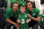 30 August 2011; Republic of Ireland players Liam Lawrence and Stephen Kelly, right, pictured with Ben Brogan McNamara, age 6, from Tallaght, at a surprise Three Trade In visit to Champion, Jervis Street. Three is asking Irish fans to Go Green With Pride and trade in their old Republic of Ireland football jerseys in any Champion store nationwide and get €20 off the new home jersey. The traded in jerseys will be donated to Friends In Ireland, a charity founded by Marian Finucane. The scheme will run until September 30th. Champion Sports, Jervis Centre, Dublin. Picture credit: Brian Lawless / SPORTSFILE