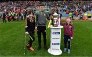 17 March 2017; Leah McMahon, Dr Crokes GAA/Holy Cross, Shane McAllister, Dr Crokes GAA/St Oliver's NS, and Megan McEldowney, Slaughtneil NS, right, bring the Andy Merrigan Cup to the plinth on the pitch before the AIB GAA Football All-Ireland Senior Club Championship Final match between Dr. Crokes and Slaughtneil at Croke Park in Dublin.   Photo by Piaras Ó Mídheach/Sportsfile