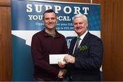 17 March 2017; Lúthchleas Gael Aogán Ó Fearghail presents Shane Carroll from Clontarf GAA Club, Dublin, who won a &quot;Shopping Voucher to the value of €1,000&quot; during the presentation of prizes to the winners of the GAA National Club Draw at Croke Park in Dublin. Uachtarán Chumann Lúthchleas Gael Aogán Ó Fearghail Photo by Ray McManus/Sportsfile