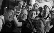 24 March 2017; (EDITORS NOTE: Image converted to black and white) Coach Mark McInerney, left, and Head of Delegation karentry Coventry, right, 'photobomb' as Team Ireland's Thomas Caulfield, a member of Stewartscare Special Olympics Club, from Ballyfermot, Dublin, takes a selfie with his Ireland T2 team mates, Matthew Colgan, a member of Estuary Centre Special Olympics Club, from Swords, Co. Dublin, Lorcan Byrne, a member of Stewartscare Special Olympics Club, from Ballyfermot, Dublin, Raymond McClearn, a member of Loughrea Training Centre Special Olympics Club, from Loughrea, Co. Galway, Patrick Tunstead, a member of Estuary Centre Special Olympics Club, from Julianstwon, Co. Meath, and Lee Ryan Byrne, a member of Sports Club 15 Special Olympics Club, from Donaghmede, Dublin, following the presentations for the Floorball competitions at the 2017 Special Olympics World Winter Games in the Messe Graz Center, Graz, Austria. Photo by Ray McManus/Sportsfile