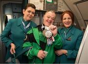 25 March 2017; Team Ireland's Cyril Walker, a member of Skiability Special Olympics Club, from Markethill, Co. Armagh, is welcomed aboard flight EI661 by Aer Lingus Cabin Crew members Laura Labuschagne, left, and Blahnaid O'Connor as the Team Ireland returned from the 2017 Special Olympics World Winter Games in Graz, Austria, at Dublin Airport in Dublin. Photo by Ray McManus/Sportsfile