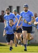26 March 2017; Dublin mascot Jamie Knott, from St Mark's National School, Tallaght, runs out with Eoghan O'Donnell of Dublin and the Dublin team before the Allianz Hurling League Division 1A Round 5 match between Dublin and Kilkenny at Parnell Park in Dublin. Photo by Brendan Moran/Sportsfile