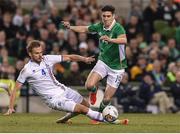 28 March 2017; Callum O'Dowda skips over a challenge by Holmar Eyjolfsson of Iceland during the International Friendly match between the Republic of Ireland and Iceland at the Aviva Stadium in Dublin. Photo by Matt Browne/Sportsfile