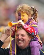 11 September 2011; Wexford supporters Cloe Whelan, age 5, with her grandfather Christy, from Wexford town,  cheer on their team before the start of the game. All-Ireland Senior Camogie Championship Final in association with RTE Sport, Galway v Wexford, Croke Park, Dublin. Picture credit: David Maher / SPORTSFILE