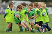 11 September 2011; Paul O'Dwyer, centre, age 7, from Naas, Co. Kildare, makes a break from the pack during the Leinster Rugby Club Open Day. Naas RFC, Co. Kildare. Picture credit: Barry Cregg / SPORTSFILE