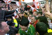 25 September 2005; Kerry player Bryan Sheehan, bottom, is helped by Security personnel and Gardai to get back to the dressing rooms after the game. Bank of Ireland All-Ireland Senior Football Championship Final, Kerry v Tyrone, Croke Park, Dublin. Picture credit; Brendan Moran / SPORTSFILE *** Local Caption *** Any photograph taken by SPORTSFILE during, or in connection with, the 2005 Bank of Ireland All-Ireland Senior Football Final which displays GAA logos or contains an image or part of an image of any GAA intellectual property, or, which contains images of a GAA player/players in their playing uniforms, may only be used for editorial and non-advertising purposes.  Use of photographs for advertising, as posters or for purchase separately is strictly prohibited unless prior written approval has been obtained from the Gaelic Athletic Association.