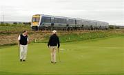 15 September 2011; Michael O'Shaughnessy, left, and Luke Glynn, Athenry Golf Club, Co. Galway, discuss their putt on the 4th green, as the Derry Express train passes by, during the Pierce Purcell Shield Semi-Final against Woodstock Golf Club, Co. Clare. Chartis Cups and Shields Finals 2011, Castlerock Golf Club, Co. Derry. Picture credit: Oliver McVeigh/ SPORTSFILE