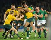 17 September 2011; Will Genia, Australia, is tackled by Ireland players Stephen Ferris, Paul O'Connell and Eoin Reddan. 2011 Rugby World Cup, Pool C, Australia v Ireland, Eden Park, Auckland, New Zealand. Picture credit: Brendan Moran / SPORTSFILE