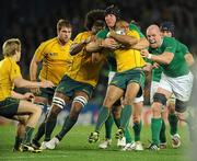 17 September 2011; Will Genia, Australia, is tackled by Ireland players Stephen Ferris and Paul O'Connell, right. 2011 Rugby World Cup, Pool C, Australia v Ireland, Eden Park, Auckland, New Zealand. Picture credit: Brendan Moran / SPORTSFILE