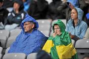 18 September 2011; Two supporters shelter from the rain. Supporters at the GAA Football All-Ireland Championship Finals, Croke Park, Dublin. Picture credit: David Maher / SPORTSFILE