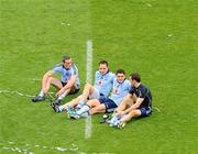 18 September 2011; Dublin players, left to right, Paul Brogan, Declan Lally, Bernard Brogan, and Denis Bastick, savour the moment by relaxing in the middle of the pitch after the game. GAA Football All-Ireland Senior Championship Final, Kerry v Dublin, Croke Park, Dublin. Picture credit: Dáire Brennan / SPORTSFILE