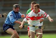 14 April 2002; Emmett McKeever of Derry in action against Ger Ennis of Dublin during the Allianz National Hurling League Division 1 Relegation Play-Off match between Dublin and Derry at Brewster Park in Enniskillen, Fermanagh. Photo by Damien Eagers/Sportsfile