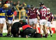 14 April 2002; Galway and Tipperary players gather around as Eamonn Corcoran of Tipperary is attended to by medical staff during the Allianz National Hurling League Quarter-Final match between Galway and Tipperary at Semple Stadium in Thurles, Tipperary. Photo by Brendan Moran/Sportsfile