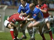 27 April 2002; Jason Holland of Munster is tackled by Gregor Townsend and Ugo Mola of Castres during the Heineken European Cup Semi-Final match between Castres and Munster at Stade de la Mediterranie in Beziers, France. Photo by Brendan Moran/Sportsfile