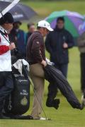 27 April 2002; Paul McGinley puts on his waterproof leggings on the 9th fairway during day three of the Smurfit Irish PGA Championship at Westport Golf Club in Westport, Mayo. Photo by David Maher/Sportsfile