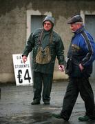 27 April 2002; Ticket sellers brave the conditions as they wait for the spectators to arrive prior to the Guinness Leinster Senior Hurling Championship First Round match between Wicklow and Laois at the County Grounds in Aughrim, Wicklow. Photo by Aoife Rice/Sportsfile