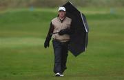 27 April 2002; Paul McGinley uses his umbrella to shield from the rain as he walks toward his ball on the 10th fairway during day three of the Smurfit Irish PGA Championship at Westport Golf Club in Westport, Mayo. Photo by David Maher/Sportsfile