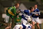 28 April 2002; Paul McDonald of Laois is tackled by Colm Cooper of Kerry during the Allianz National Football League Division 2 Final match between Kerry and Laois at the Gaelic Grounds in Limerick. Photo by Brendan Moran/Sportsfile