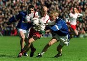 28 April 2002; Peter Canavan of Tyrone in action against Michael Bridges of Cavan during the Allianz National Football League Division 1 Final match between Tyrone and Cavan at St Tiernach's Park in Clones, Monaghan. Photo by Pat Murphy/Sportsfile