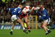 28 April 2002; Ryan McMenamin of Tyrone in action against Michael Bridges, 5, and Paul Galligan of Cavan during the Allianz National Football League Division 1 Final match between Tyrone and Cavan at St Tiernach's Park in Clones, Monaghan. Photo by Damien Eagers/Sportsfile