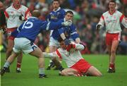 28 April 2002; Brian Robinson of Tyrone in action against Larry Reilly and Mickey Graham, 15, of Cavan during the Allianz National Football League Division 1 Final match between Tyrone and Cavan at St Tiernach's Park in Clones, Monaghan. Photo by Pat Murphy/Sportsfile