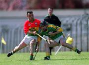 28 April 2002; Thomas Reilly of Meath is tackled by Johnny Nevin of Carlow during the Guinness Leinster Senior Hurling Championship First Round match between Carlow and Meath at Dr Cullen Park in Carlow. Photo by Ray McManus/Sportsfile