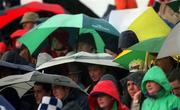 28 April 2002; Supporters shelter from the rain during the Allianz National Football League Division 1 Final match between Tyrone and Cavan at St Tiernach's Park in Clones, Monaghan. Photo by Damien Eagers/Sportsfile