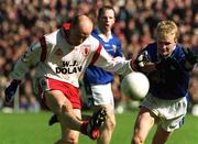 28 April 2002; Peter Canavan of Tyrone in action against Michael Brides of Cavan during the Allianz National Football League Division 1 Final match between Tyrone and Cavan at St Tiernach's Park in Clones, Monaghan. Photo by Pat Murphy/Sportsfile