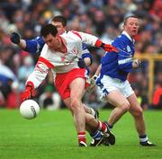 28 April 2002; Brian Robinson of Tyrone in action against Larry Reilly of Cavan during the Allianz National Football League Division 1 Final match between Tyrone and Cavan at St Tiernach's Park in Clones, Monaghan. Photo by Pat Murphy/Sportsfile