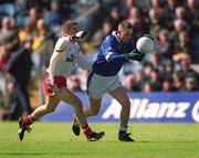 28 April 2002; Paul Galligan of Cavan in action against Philip Jordan of Tyrone during the Allianz National Football League Division 1 Final match between Tyrone and Cavan at St Tiernach's Park in Clones, Monaghan. Photo by Damien Eagers/Sportsfile