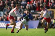 28 April 2002; Paul Galligan of Cavan in action against Philip Jordan, left, and Ciaran Gourley of Tyrone during the Allianz National Football League Division 1 Final match between Tyrone and Cavan at St Tiernach's Park in Clones, Monaghan. Photo by Damien Eagers/Sportsfile