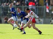28 April 2002; Brian Dooher of Tyrone in action against Paul Galligan of Cavan during the Allianz National Football League Division 1 Final match between Tyrone and Cavan at St Tiernach's Park in Clones, Monaghan. Photo by Damien Eagers/Sportsfile
