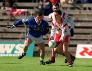 28 April 2002; Brian Robinson of Tyrone in action against Eddie Reilly of Cavan during the Allianz National Football League Division 1 Final match between Tyrone and Cavan at St Tiernach's Park in Clones, Monaghan. Photo by Damien Eagers/Sportsfile