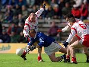 28 April 2002; Jason Reilly of Cavan in action against Chris Lawn, left, and Ciaran Gourley, 6, of Tyrone during the Allianz National Football League Division 1 Final match between Tyrone and Cavan at St Tiernach's Park in Clones, Monaghan. Photo by Damien Eagers/Sportsfile