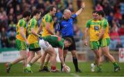 2 April 2017; Referee Cormac Reilly brings the ball forward for a Mayo free following the protests of Donegal players during the Allianz Football League Division 1 Round 7 match between Mayo and Donegal at Elverys MacHale Park in Castlebar, Co Mayo. Photo by Stephen McCarthy/Sportsfile