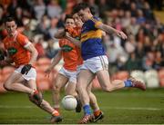 2 April 2017; Michael Quinlivan of Tipperary shoots to score his side's first goal despite the challenge of Charlie Vernon of Armagh  during the Allianz Football League Division 3 Round 7 match between Armagh and Tipperary at the Athletic Grounds in Armagh. Photo by Oliver McVeigh/Sportsfile