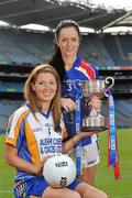 20 September 2011; Ahead of the TG4 Ladies Football All-Ireland Finals taking place this Sunday in Croke Park, the captains and managers from all six competing counties met in Crokes Park. New York captain Rosie O'Reilly, right, and Wicklow captain Catriona McKeon with the West County Hotel Cup ahead of the TG4 Junior Final which throws in at 12pm. 2011 TG4 All-Ireland Ladies Football Final Captain's Day, Croke Park, Dublin. Picture credit: David Maher / SPORTSFILE