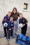 21 September 2011; Dublin's Bernard Brogan with Kilmacud Crokes club members Conor Hall, age 11, his brother Cormac, age 6, and Ben Hynes before the game. Challenge game in aid of Crosscare and Temple Street Hospital, Dublin v Kilmacud Crokes, Parnell Park, Dublin. Picture credit: Ray McManus / SPORTSFILE
