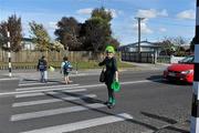22 September 2011; A member of the school staff helps children across the pedestrian crossing after a visit by Ireland players Stephen Ferris, Damien Varley and Conor Murray to Selwyn Primary School ahead of their 2011 Rugby World Cup, Pool C, game against Russia on Sunday. Selwyn Primary School, Rotorua, New Zealand. Picture credit: Brendan Moran / SPORTSFILE