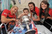 26 September 2011; Nathan O'Brien, age 5, from Finglas, Dublin, with Cork players, from left to right, Amy O'Shea, Annie Walsh and Orlagh Farmer, holding the Brendan Martin Cup, during a visit to Temple Street Children's University Hospital, Temple Street, Dublin. Picture credit: David Maher / SPORTSFILE