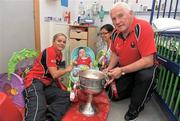 26 September 2011; Cork manager Eamon Ryan and captain Amy O'Shea with 10 month old Mark Sheehan, from Glenville, Co. Cork, and nurse Jemma Mabenas, with the Brendan Martin Cup, during a visit to Temple Street Children's University Hospital, Temple Street, Dublin. Picture credit: David Maher / SPORTSFILE