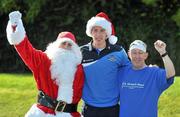 28 September 2011; St. Michael's House, Ireland's largest provider of community-based services for people with an intellectual disability, has teamed up with The Carers Association Ireland to launch the third annual 'Santa Swim' in an attempt to pack Santa's sleigh with educational and sporting equipment for St. Michael's House and support The Carers Association's respite hours, outreach services and National Care Line in time for Christmas! Across the country relay teams are gearing up to do their lengths for the charities. At the launch is Dublin footballer Barry Cahill with Santa Claus and Charlie Hughes, a service user at Moyles Road, Glasnevin. National Aquatic Centre, Abbotstown, Dublin. Picture credit: Brian Lawless / SPORTSFILE