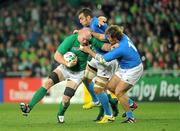 2 October 2011; Paul O'Connell, Ireland, is tackled by Quintin Geldenhuys and Andrea Lo Cicero, right, Italy. 2011 Rugby World Cup, Pool C, Ireland v Italy, Otago Stadium, Dunedin, New Zealand. Picture credit: Brendan Moran / SPORTSFILE