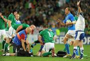 2 October 2011; Ireland's Paul O'Connell checks on the welfare of team-mate Cian Healy as referee Jonathan Kaplan gives a penalty to Italy. 2011 Rugby World Cup, Pool C, Ireland v Italy, Otago Stadium, Dunedin, New Zealand. Picture credit: Brendan Moran / SPORTSFILE