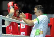 3 October 2011; David Oliver Joyce, St Michael's Athy B.C., Kildare, representing Ireland, has his headgear adjusted by coach Billy Walsh ahead of his 60kg bout with Mohammad Khaiber, Afghanistan. Joyce advanced to the Last 16 with a 26-13 victory. 2011 AIBA World Boxing Championships - Last 32, David Oliver Joyce v Mohammad Khaiber. Heydar Aliyev Sports and Exhibition Complex, Baku, Azerbaijan. Picture credit: Stephen McCarthy / SPORTSFILE