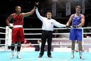 3 October 2011; Referee Meng Wang raises the hand of the victorious Jose Larduet Gomez, Cuba, following his 91kg bout with Ken Egan, Neilstown B.C., Dublin, representing Ireland. Egan, making his international debut at the heavyweight division, retired during the third round with the score reading 30-12. 2011 AIBA World Boxing Championships - Last 32, Ken Egan v Jose Larduet Gomez. Heydar Aliyev Sports and Exhibition Complex, Baku, Azerbaijan. Picture credit: Stephen McCarthy / SPORTSFILE