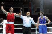 4 October 2011; Referee Bahodir Jumaniyazov, Uzbekistan, raises the hand of Ehsan Rouzbahani, Iran, following his 81kg bout victory over Joe Ward, Moate B.C., Westmeath, representing Ireland. Ward was defeated on countback after the bout ended 15-15. 2011 AIBA World Boxing Championships - Last 16, Joe Ward v Ehsan Rouzbahani. Heydar Aliyev Sports and Exhibition Complex, Baku, Azerbaijan. Picture credit: Stephen McCarthy / SPORTSFILE
