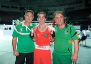 4 October 2011; Michael Conlan, St. John Bosco B.C., Belfast, Antrim, representing Ireland, following his 52kg bout victory over Nordine Oubaali, France, with coaches Billy Walsh and Zaur Antia. Conlan won the contest 20-17 and ensured progression to the Quarter-Finals and also qualification for the London 2012 Olympic Games. 2011 AIBA World Boxing Championships - Last 16, Michael Conlan v Nordine Oubaali. Heydar Aliyev Sports and Exhibition Complex, Baku, Azerbaijan. Picture credit: Stephen McCarthy / SPORTSFILE